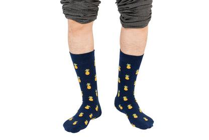 Person wearing Pineapple Socks, standing heel to toe with legs slightly apart and pants rolled up to the knees, exuding an air of tropical comfort.