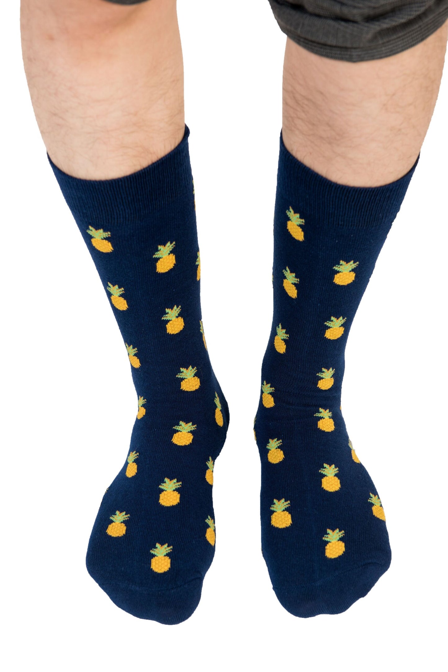 A person's legs wearing Pineapple Socks deliver tropical comfort from heel to toe.