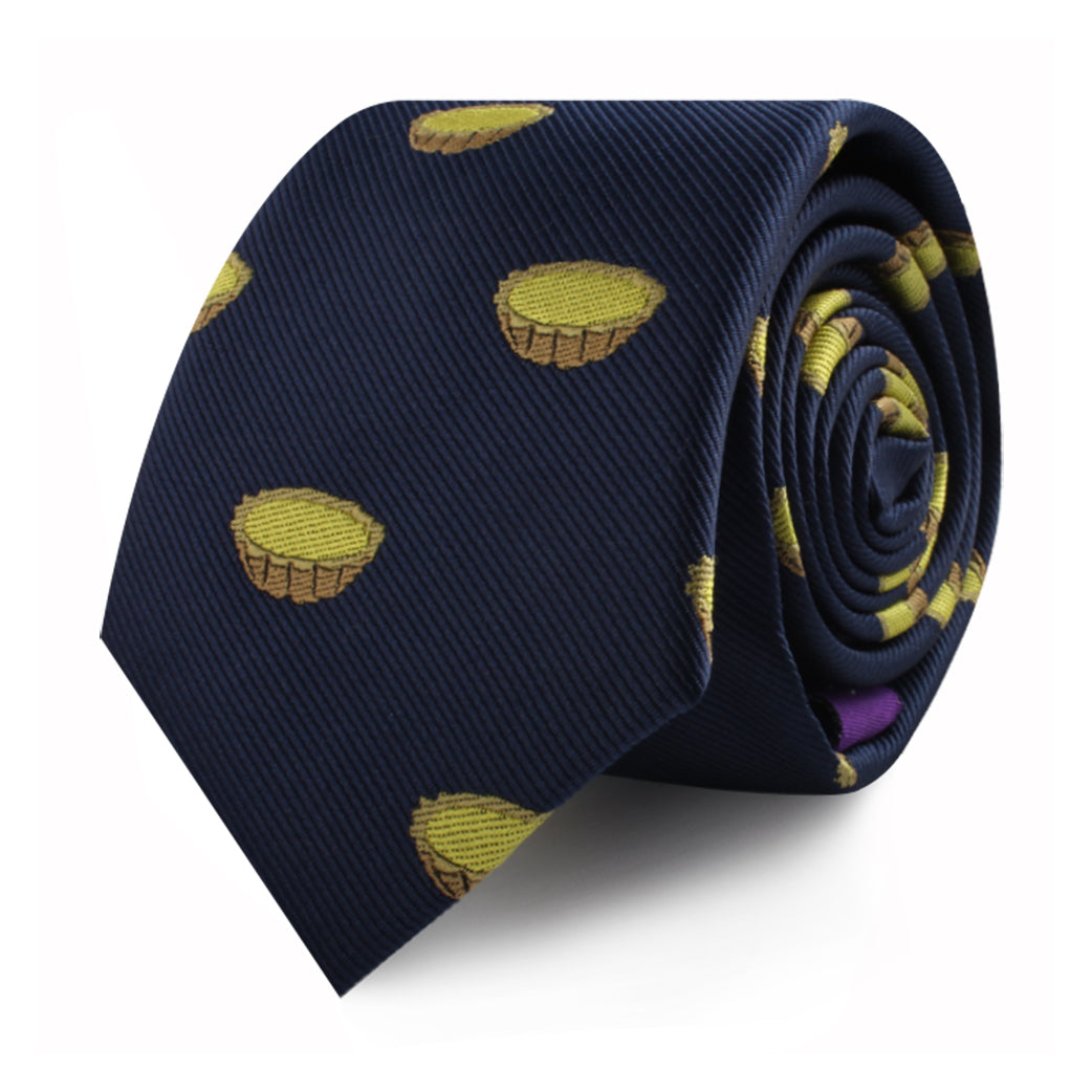 A rolled Egg Tart Skinny Tie, featuring charming yellow pastry illustrations on navy blue, adds a touch of charm to your fashion ensemble.