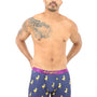 A shirtless man wearing the Duck Underwear, featuring navy blue boxer briefs adorned with yellow rubber duck prints and a purple waistband, stands against a white background, exuding plush comfort.