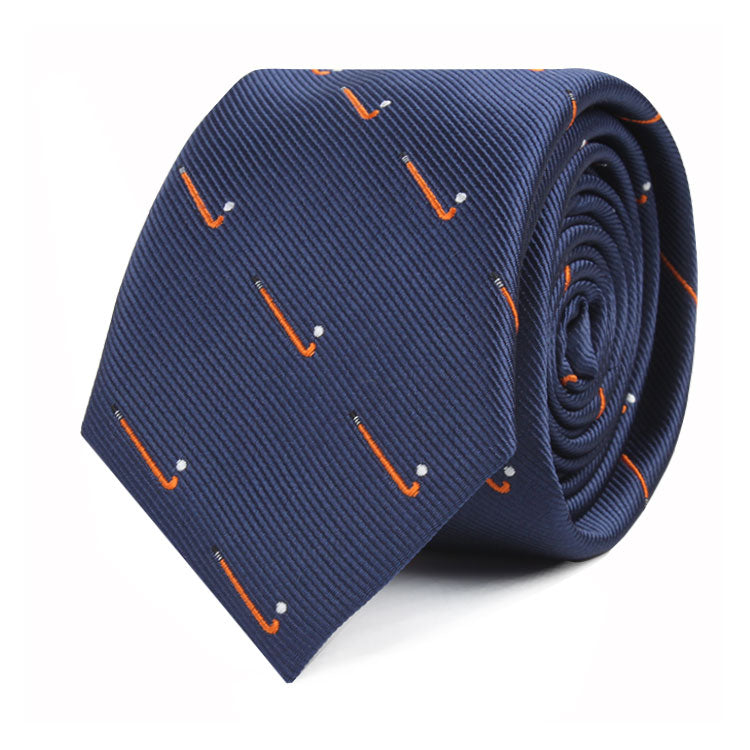 A rolled-up Field Hockey Skinny Tie featuring motifs of orange hockey sticks and white pucks, capturing a touch of athletic spirit.