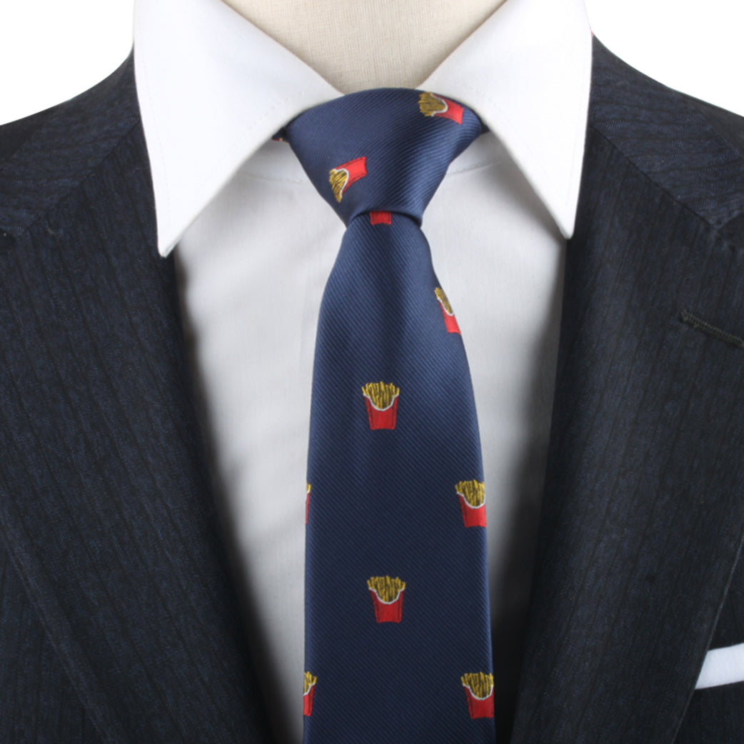 Close-up of a person wearing a dark suit with a white shirt and the Fries Skinny Tie, adorned with small French fry containers, exuding modern sophistication.