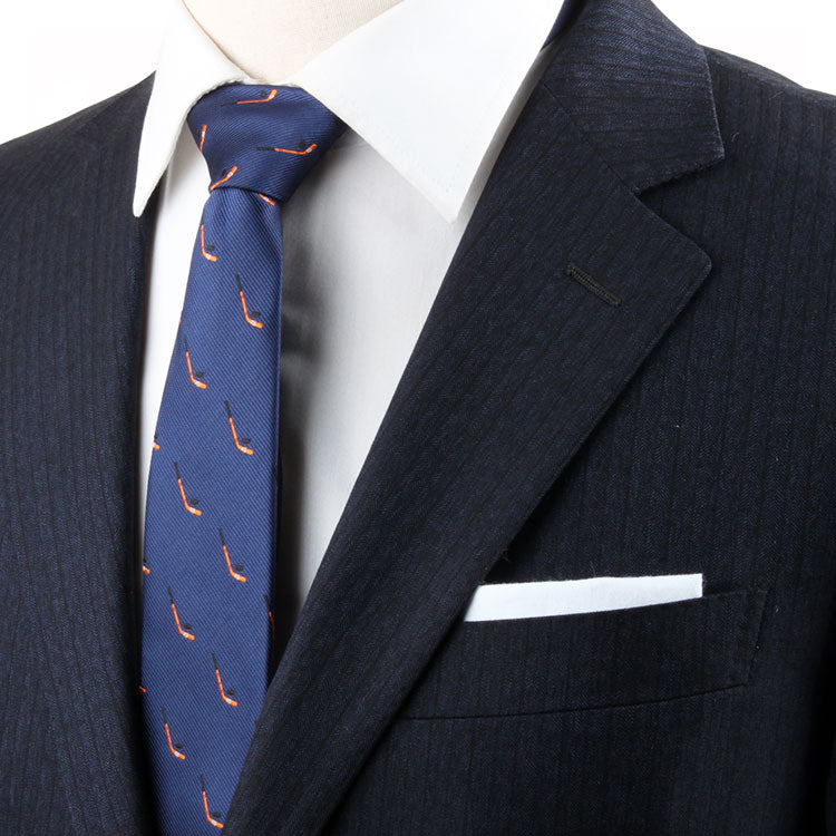 A person in a dark suit, white shirt, and Ice Hockey Skinny Tie, exuding a timeless allure.