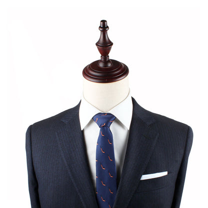 A mannequin dressed in a dark navy suit, white dress shirt, and Field Hockey Skinny Tie with red accents, with a white pocket square. The subtle motifs on the tie add an extra touch of elegance, reflecting an athletic spirit that complements the sharp ensemble perfectly.