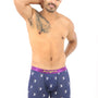 A person stands confidently in Basketball Dunk Underwear, featuring navy printed boxer briefs with a pink waistband, striking a pose with one hand behind their head and the other on their hip, exuding comfort like a natural in hoops.