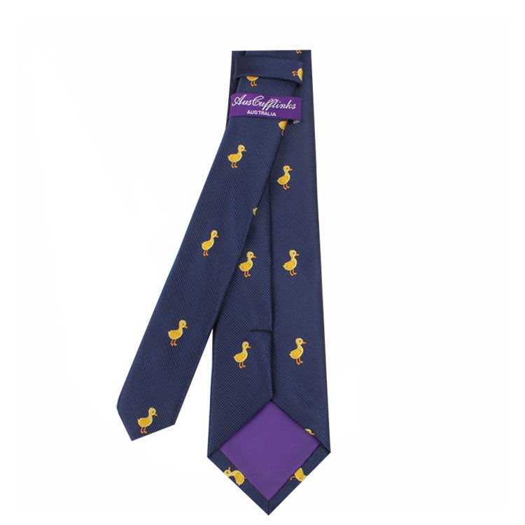 Duck Skinny Tie: A navy blue tie with a charming duck pattern, featuring a yellow design that adds an element of cuteness, complemented by a purple inner label and lining.