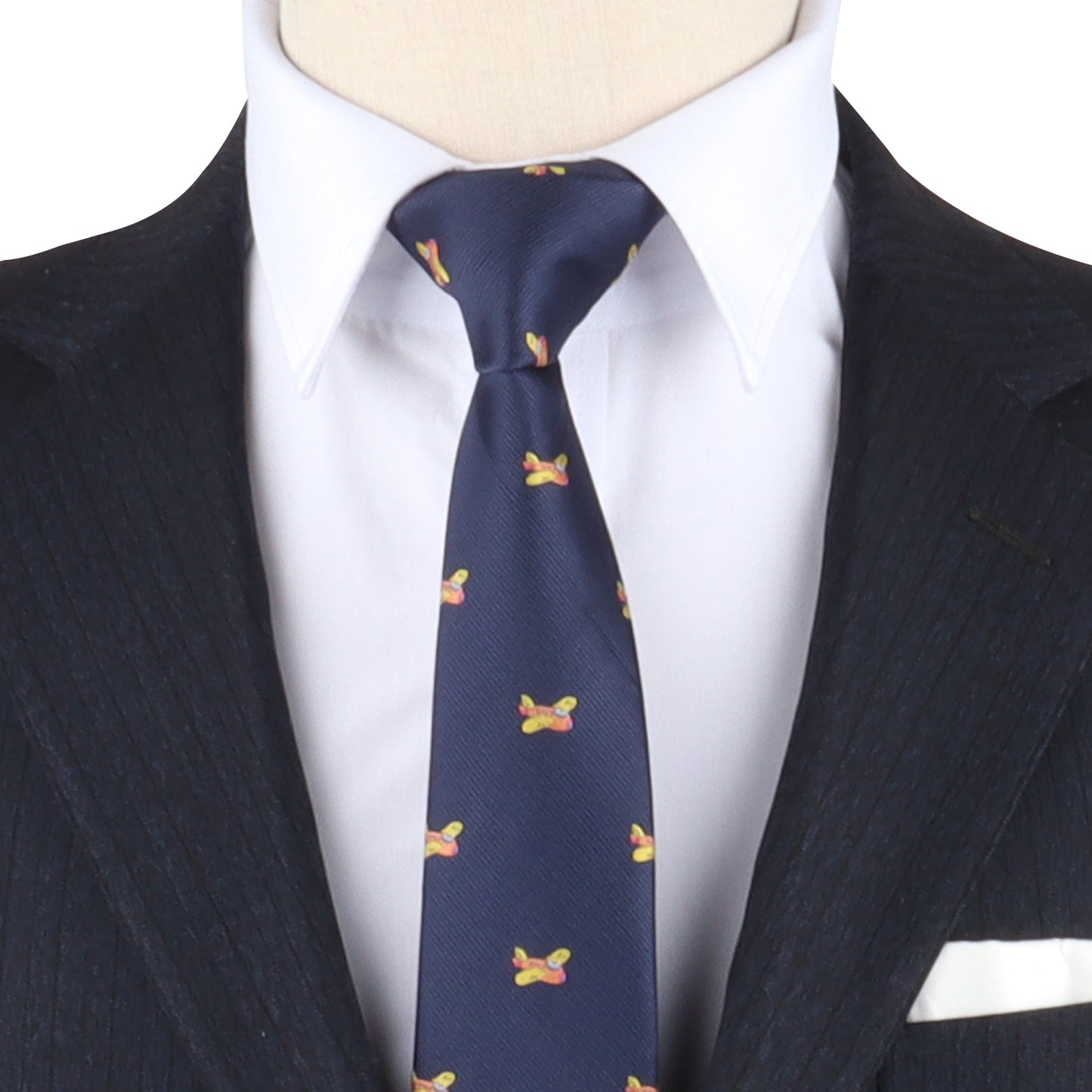 A navy blue suit with a white shirt and the stylish Orange Aircraft Skinny Tie, featuring vibrant hues in its pattern of small colorful designs.