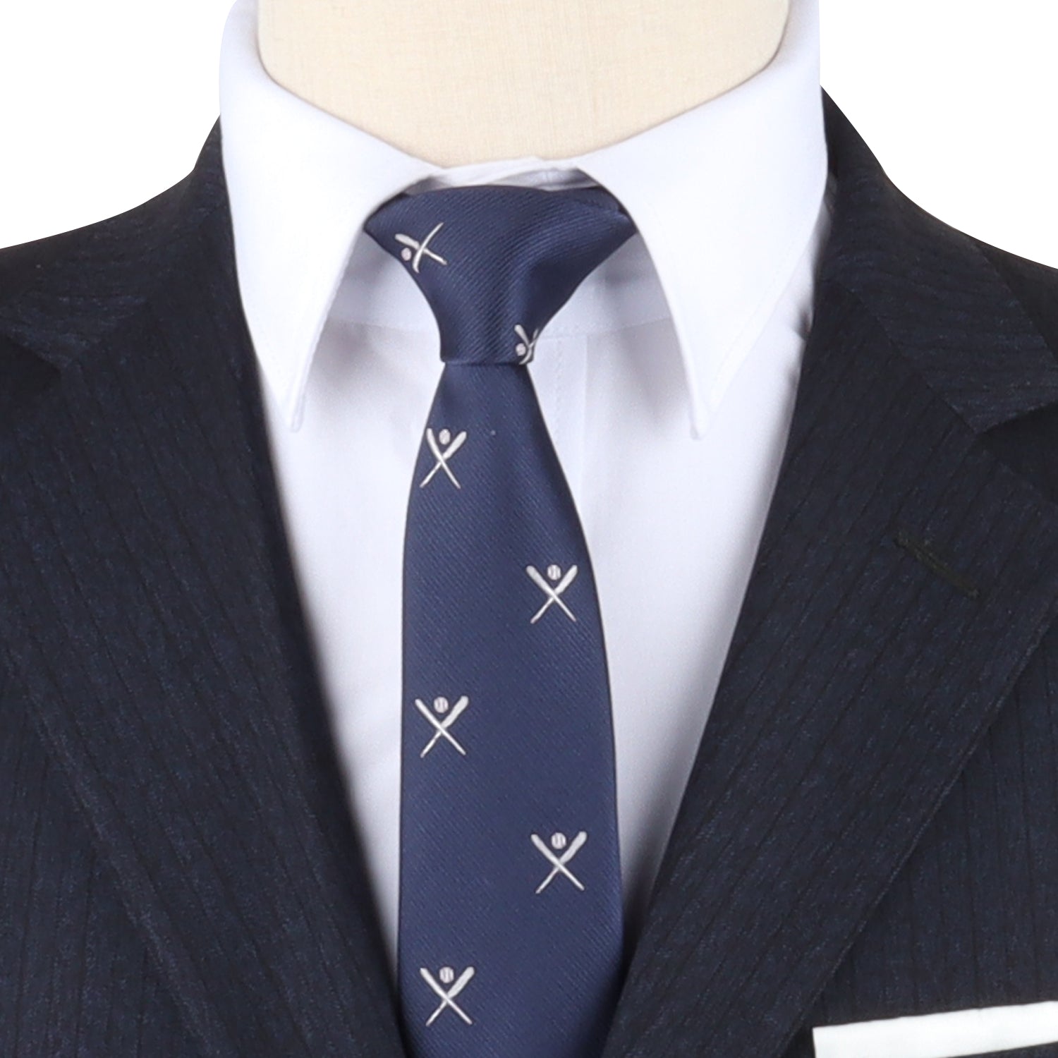 A mannequin dressed in a dark pinstriped suit, white dress shirt, and the Crossed Baseball Skinny Tie exudes elegance and sophistication for any occasion.