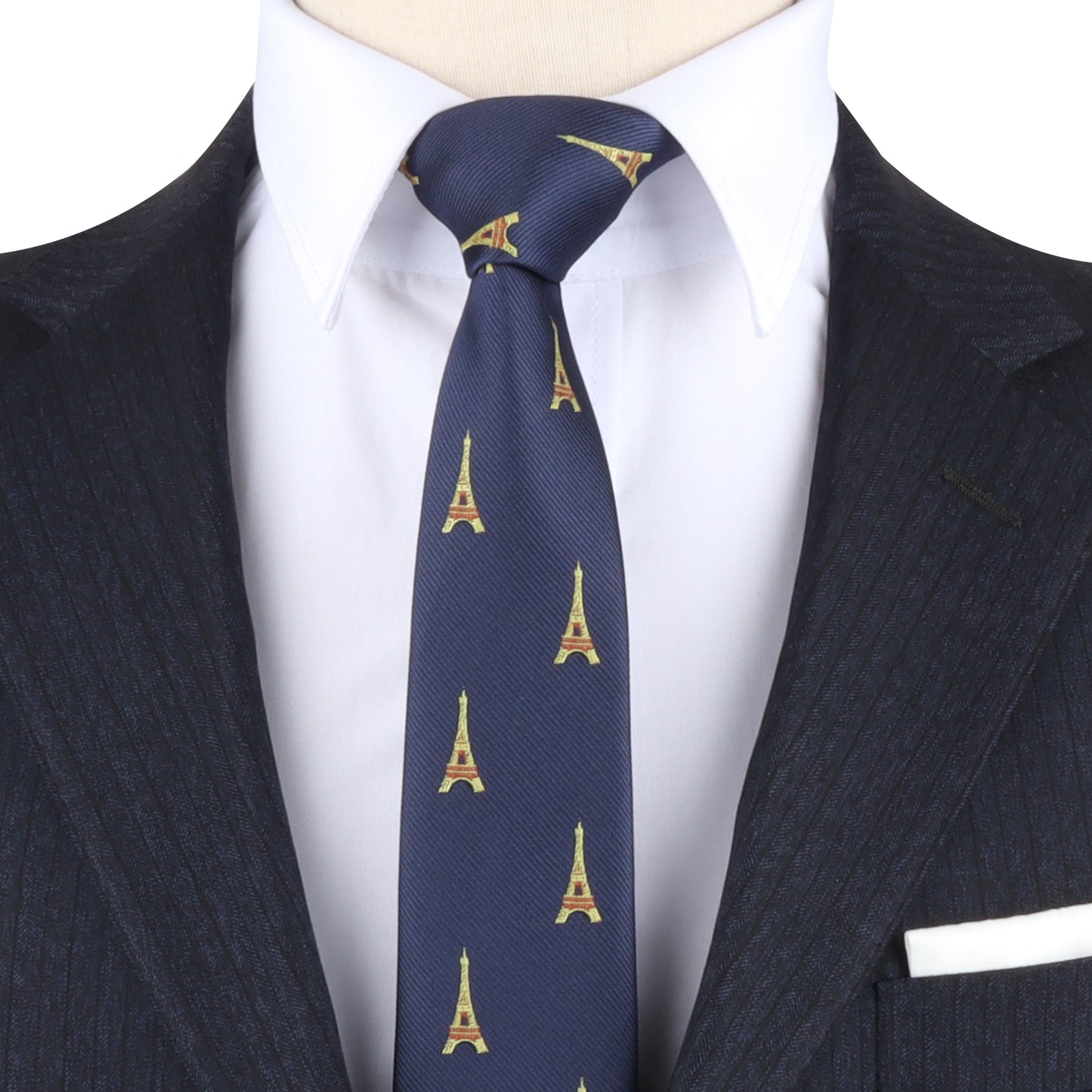 Close-up of a person wearing a dark pinstripe suit, white dress shirt, and the Eiffel Tower Skinny Tie that exudes Parisian elegance.