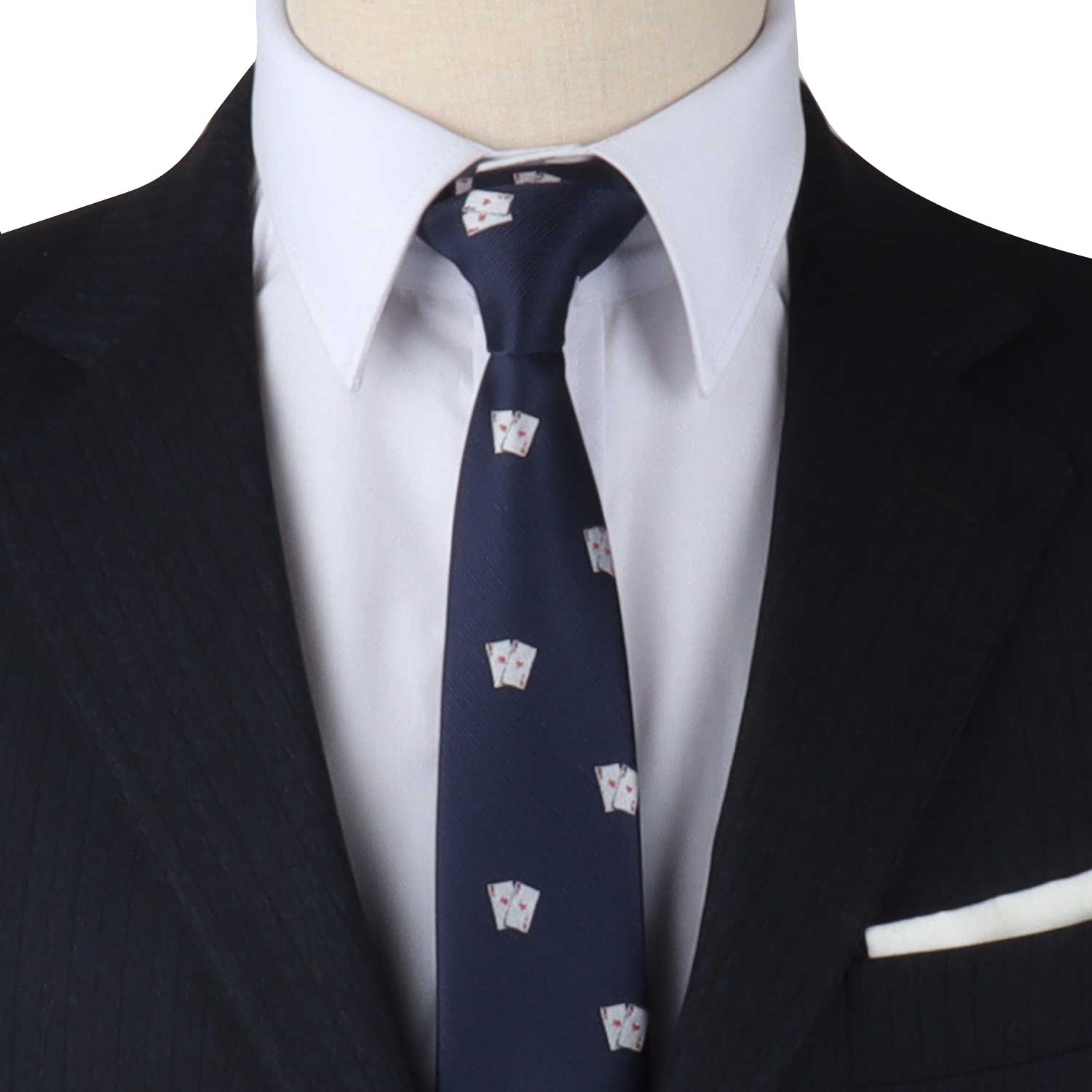 Close-up of a person in a black suit, white dress shirt, and the Poker Cards Skinny Tie with small white designs. A white pocket square is visible in the jacket's breast pocket, ready to elevate your style.