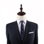 A mannequin dressed in a dark formal suit, white dress shirt, and an Orange Skinny Tie exudes charm.