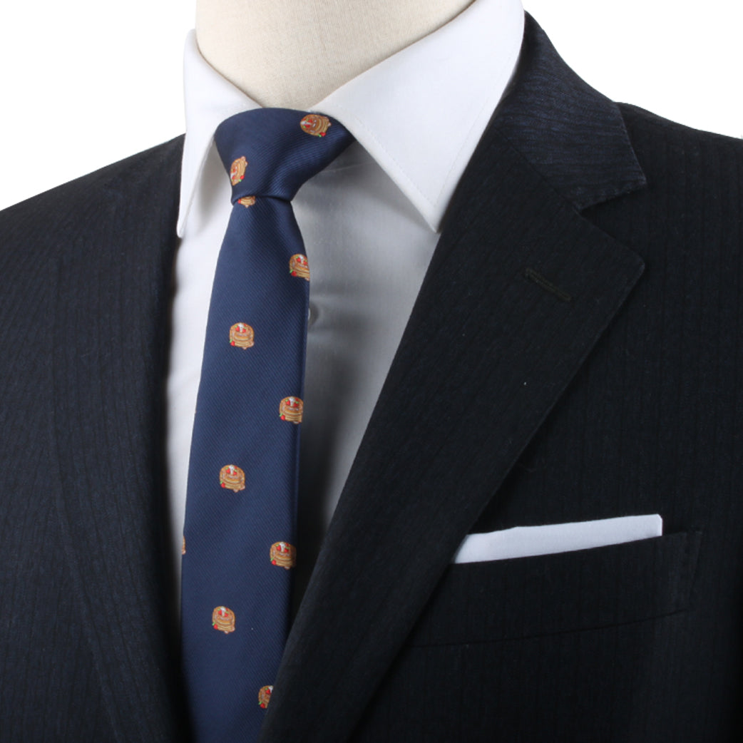 Close-up of a mannequin dressed in a navy suit with a Pancakes Skinny Tie and white pocket square.