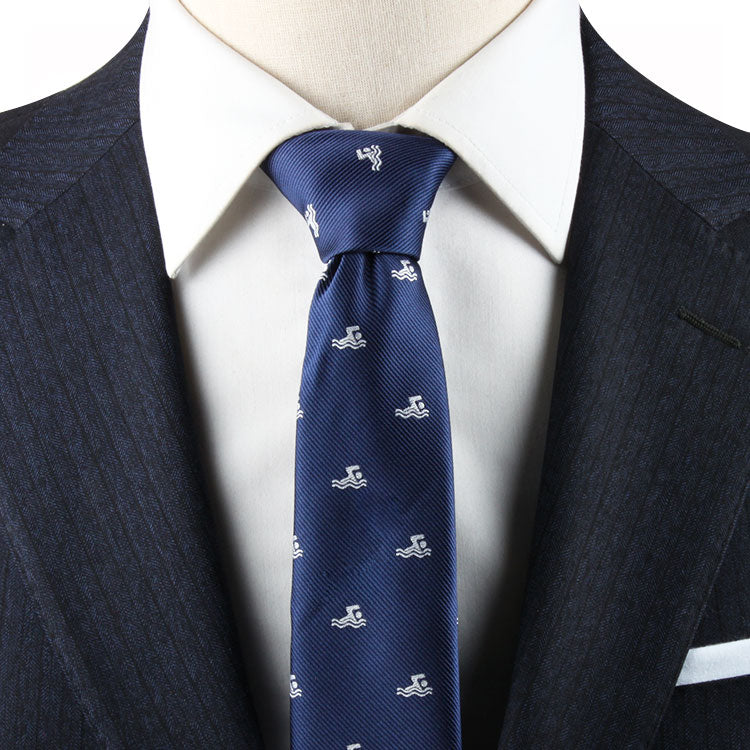 Mannequin dressed in a timeless style, navy suit jacket with a white shirt and Swimming Skinny Tie featuring an aquatic grace pattern of small white animals.