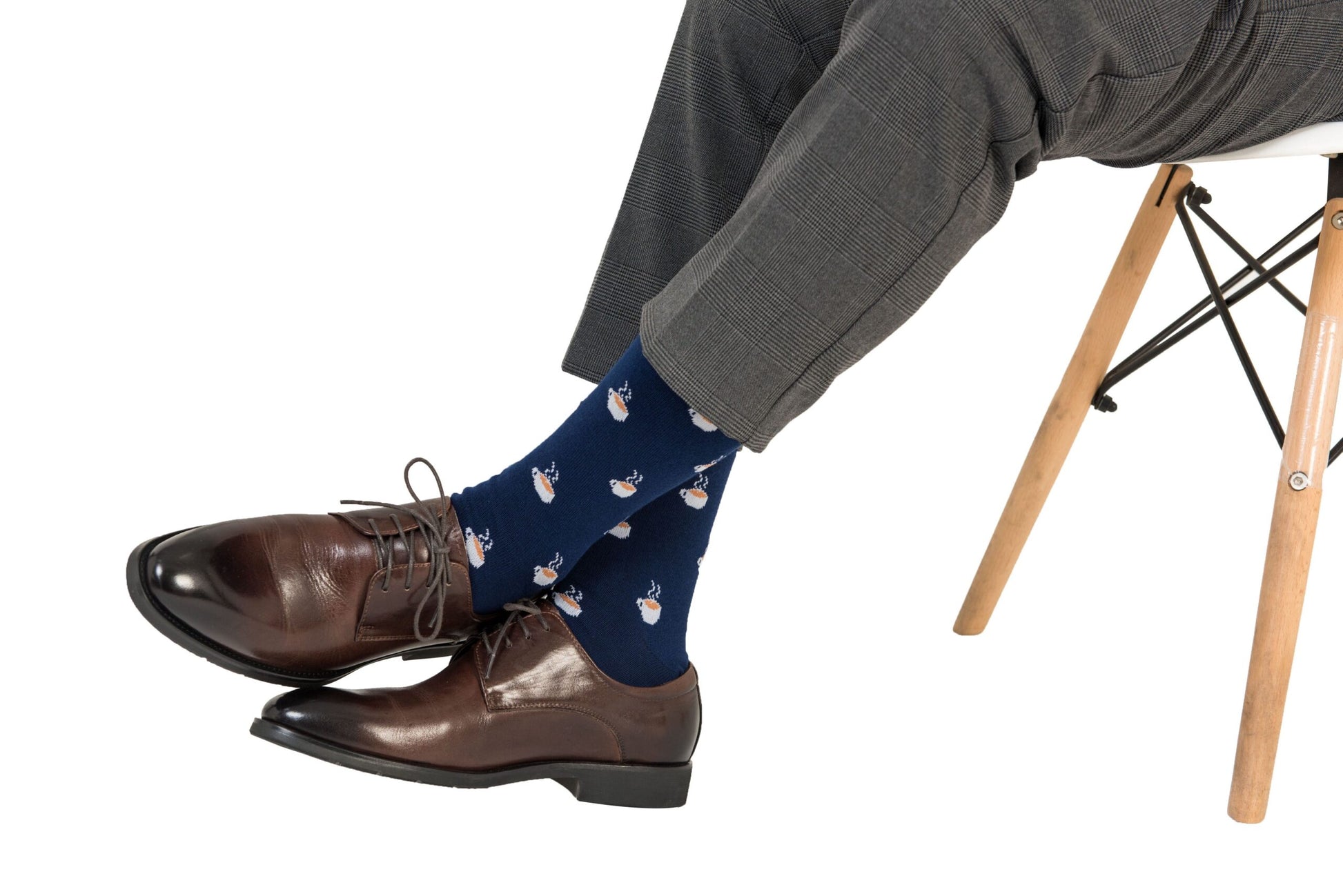 A man sitting on a chair wearing a pair of Coffee Socks.