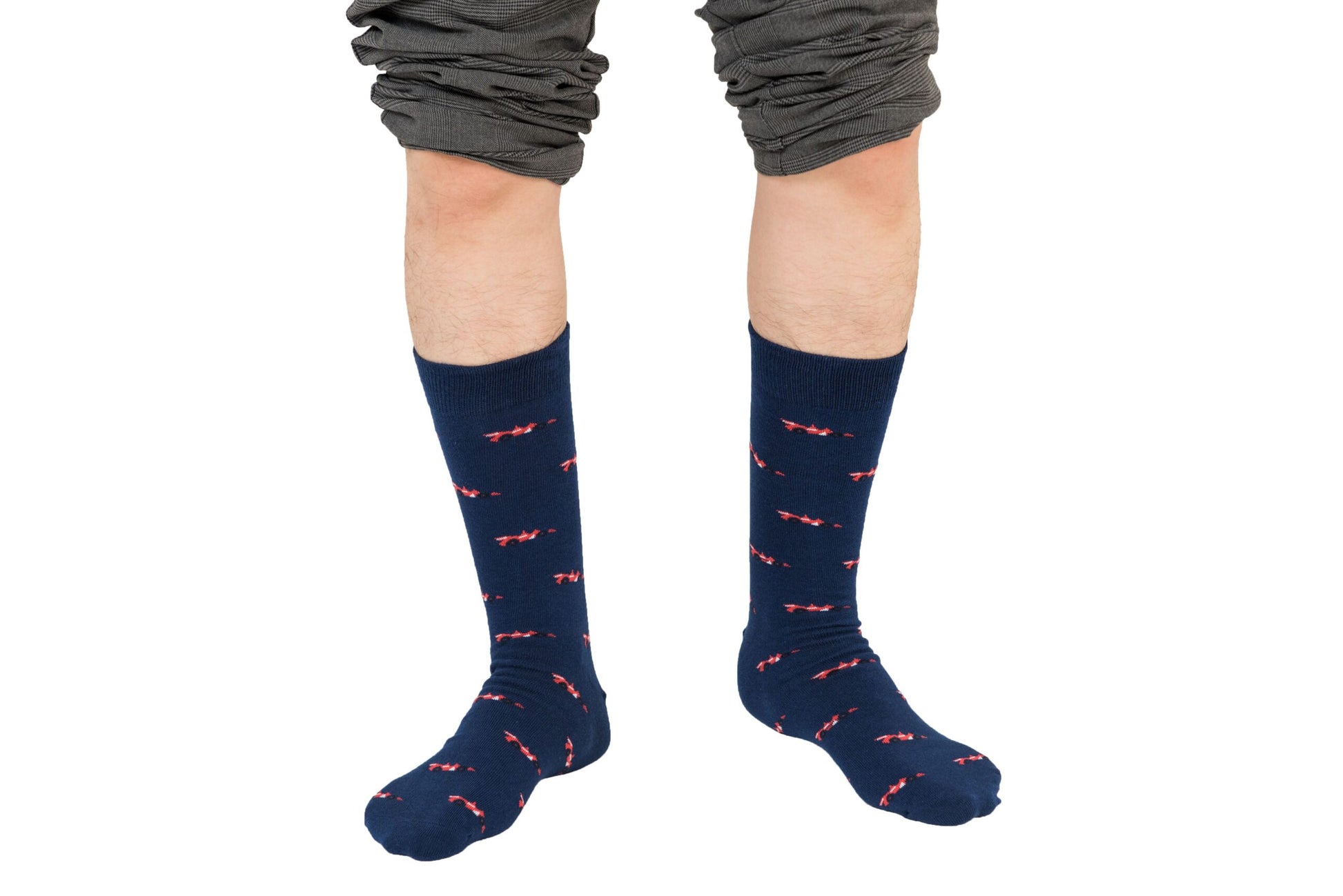 A boy wearing a pair of Racing Car Socks with an accelerated red bow on them, showcasing his impressive sock game.