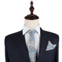 A mannequin displays a dark suit with a white shirt, flawlessly coordinated with the Blue Paisley Skinny Necktie and matching Pocket Square Set.