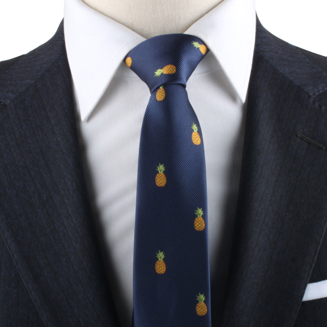 A close-up of a person wearing a dark pinstripe suit, white shirt, and a Pineapple Skinny Tie exudes modern elegance with a hint of tropical allure.