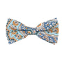 The Blue Paisley Bow Tie and Pocket Square Set exudes style with its vibrant blend of blue, orange, and white tones.