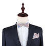 The mannequin dressed in a dark suit with the Blue Latte Brown Paisley Bow Tie and matching pocket square exudes rich blends of sophisticated style.