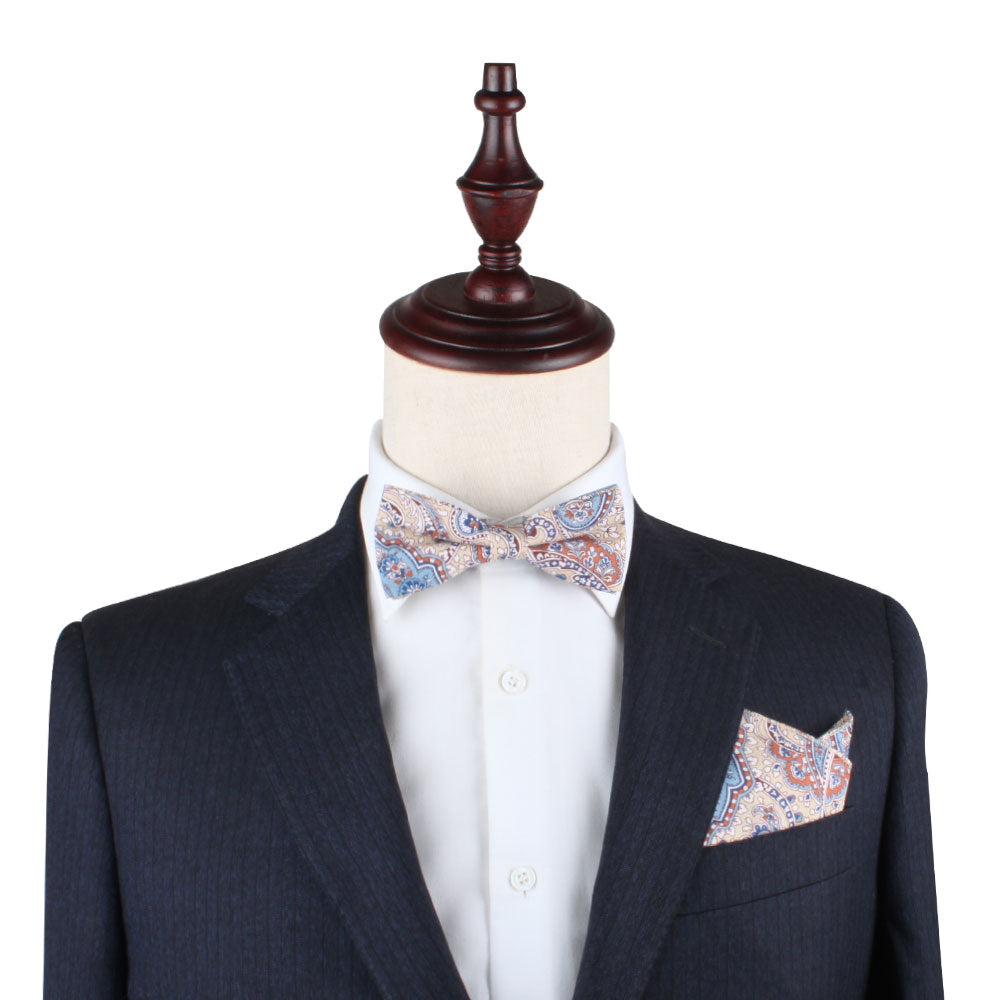 A Blue Latte Brown Paisley Bow Tie and Pocket Square Set with a paisley pattern in harmonious hues on a mannequin.