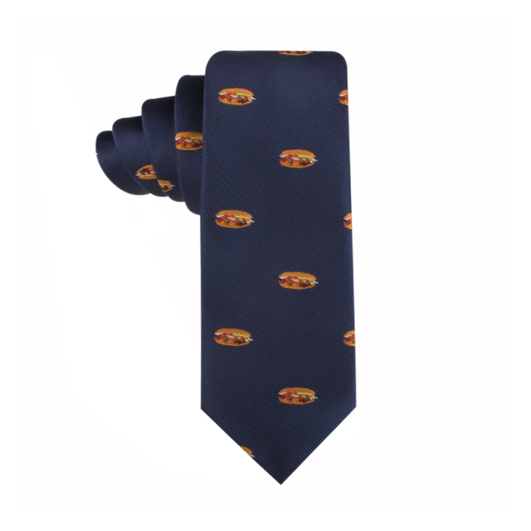 A Pork Roll Skinny Tie, featuring a blue background with a repeating pattern of small colorful crests, brings a touch of modern charm.