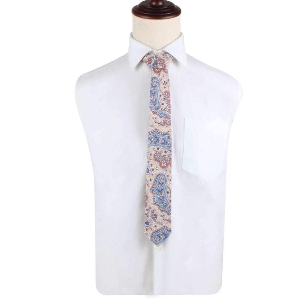 A mannequin torso exudes charm as it showcases a white dress shirt with a pocket, perfectly complemented by the Blue Latte Brown Paisley Skinny Necktie and Pocket Square Set.