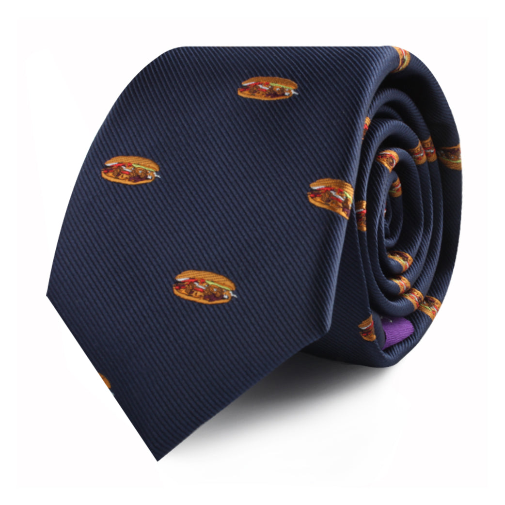 A rolled-up Pork Roll Skinny Tie in navy blue, featuring a playful pattern of small hamburger images scattered across the fabric, adding a touch of modern charm inspired by comfort food.