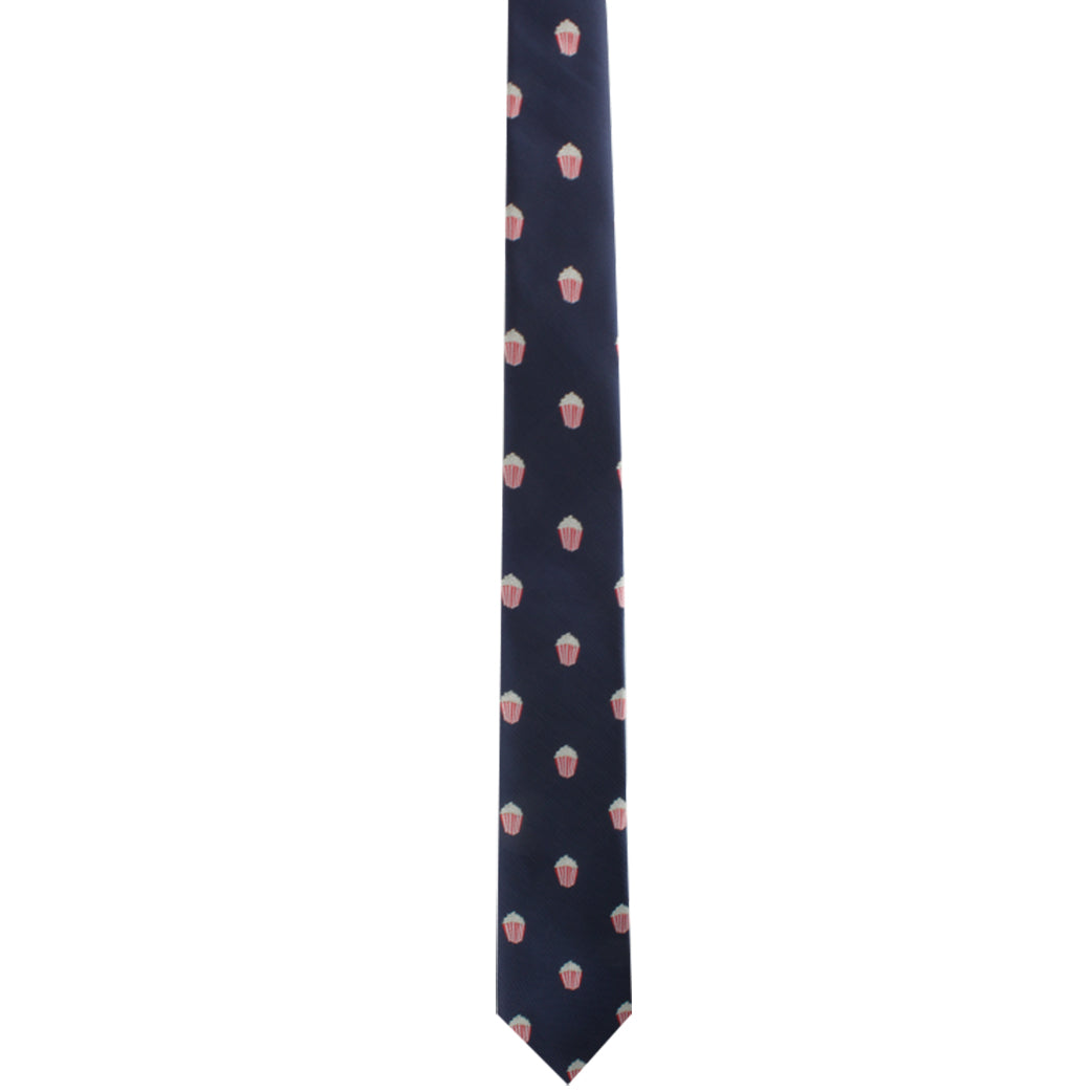 A navy blue Popcorn Skinny Tie with a pattern of small pink and white cupcake motifs makes a cinematic statement to your style.