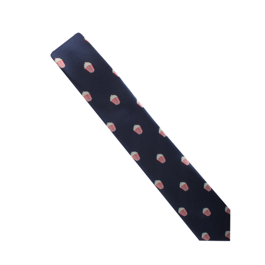 A dark blue Popcorn Skinny Tie featuring a pattern of small red and white strawberry motifs, perfect for making a subtle yet stylish statement.