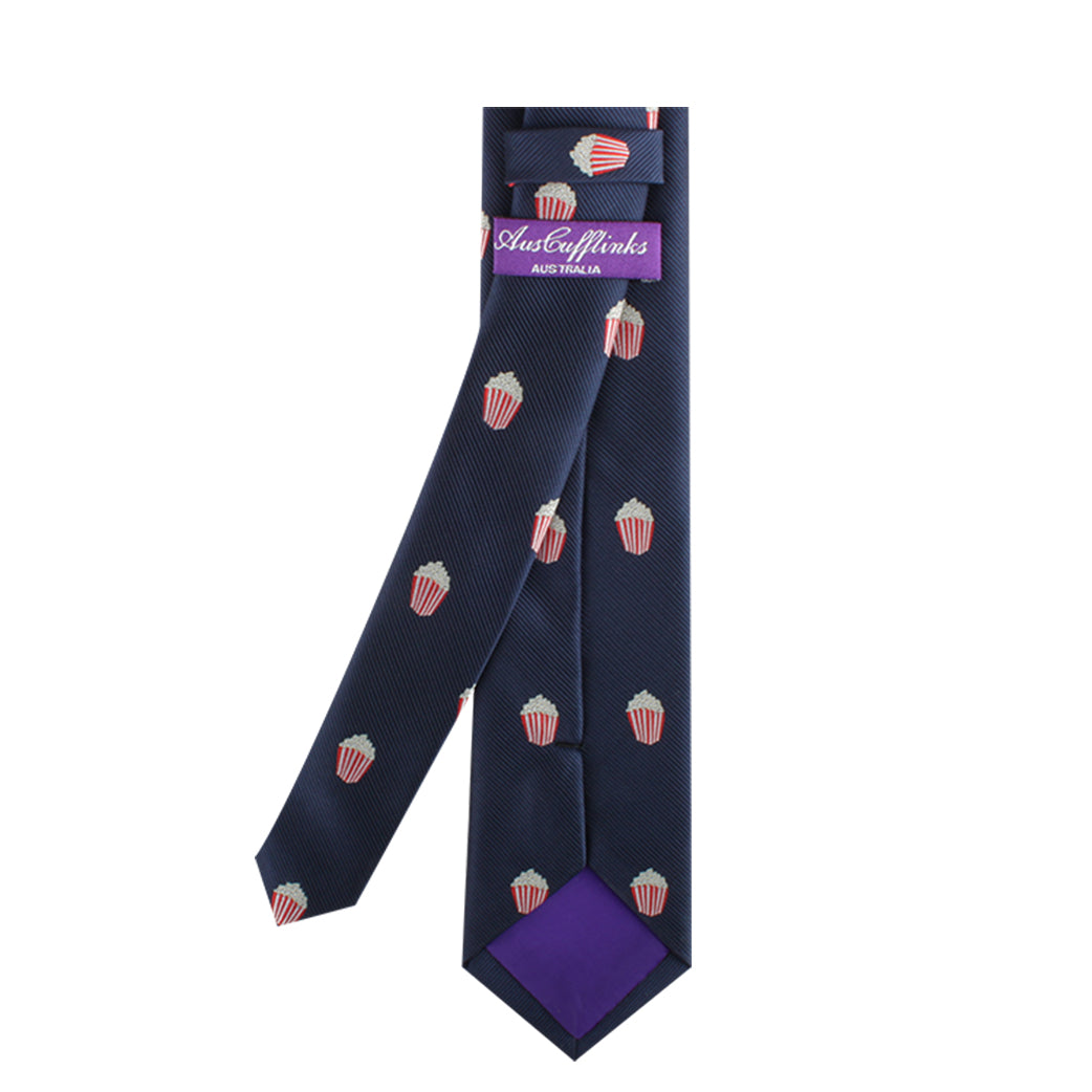 A Popcorn Skinny Tie featuring a pattern of popcorn buckets, with a purple label reading "Ashen Aftanks" near the back. The tie has a purple inner lining at the bottom, making it a perfect statement piece for cinematic style enthusiasts.