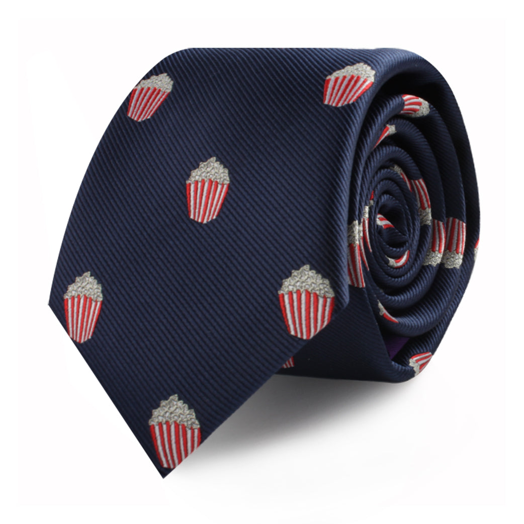 A stylish rolled-up navy blue Popcorn Skinny Tie adorned with red and white striped popcorn bucket patterns, making a bold cinematic statement.