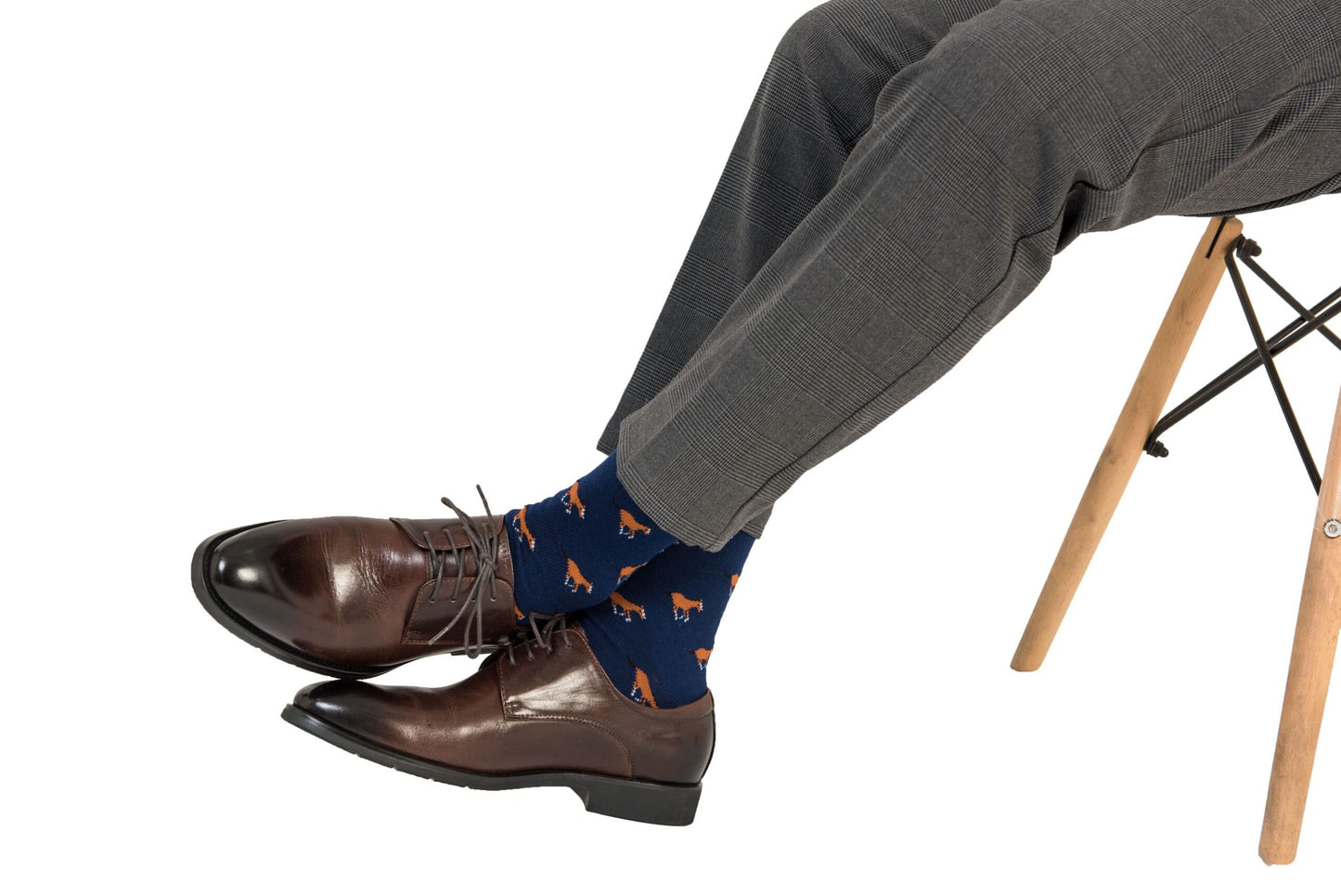 A man sitting on a chair wearing a pair of Horse Socks.