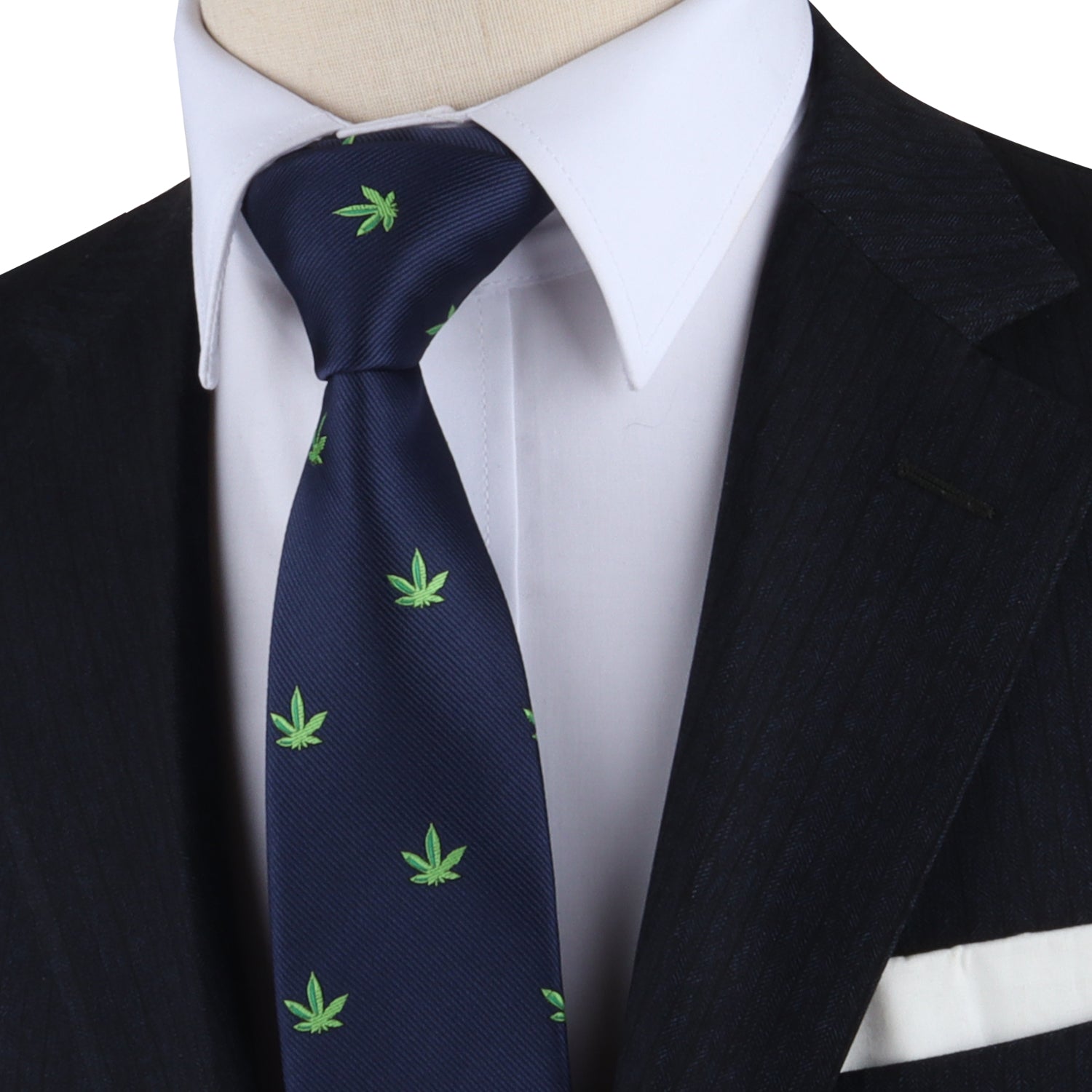 A person making a bold statement with the Weed Skinny Tie, featuring green leaf patterns on navy, complemented by a white shirt and dark suit jacket.