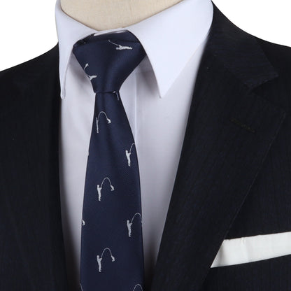 Close-up of a person wearing a navy blue suit jacket, a white dress shirt, and a Fisherman Skinny Tie with a fishing hook pattern. A white pocket square effortlessly complements the ensemble, reeling in attention to this impeccably styled look.