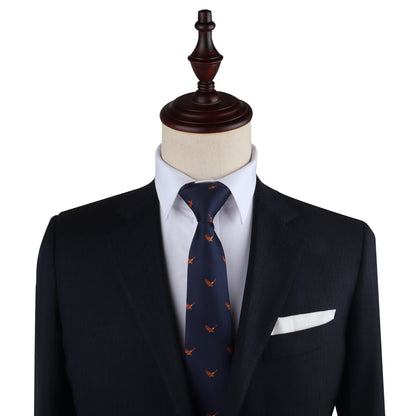 A mannequin dressed in a dark suit with a white dress shirt, the Flying Eagle Skinny Tie featuring blue tones and orange accents, and a white pocket square captures the essence of majestic fashion.