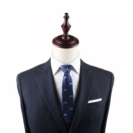 A mannequin displays a dark suit with a white dress shirt, a Dolphin Skinny Tie, and a white pocket square, perfect for ocean enthusiasts.