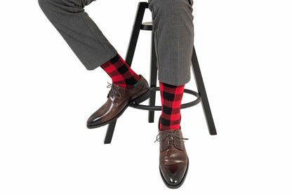 A man sitting on a stool wearing Cross Hatch Stripes socks.