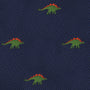 The Stegosaurus Bow Tie features a navy blue fabric adorned with small embroidered green dinosaurs, each sporting orange spines, adding a touch of prehistoric panache.