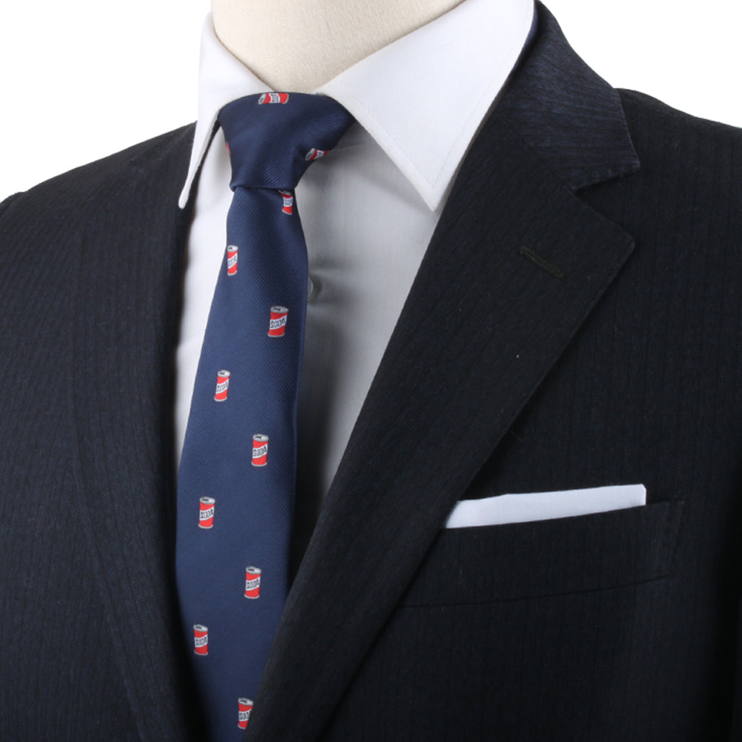 Mannequin showcasing a dark suit and white shirt, accentuated by the refreshing Soda Skinny Tie adorned with small red and white pop can designs.