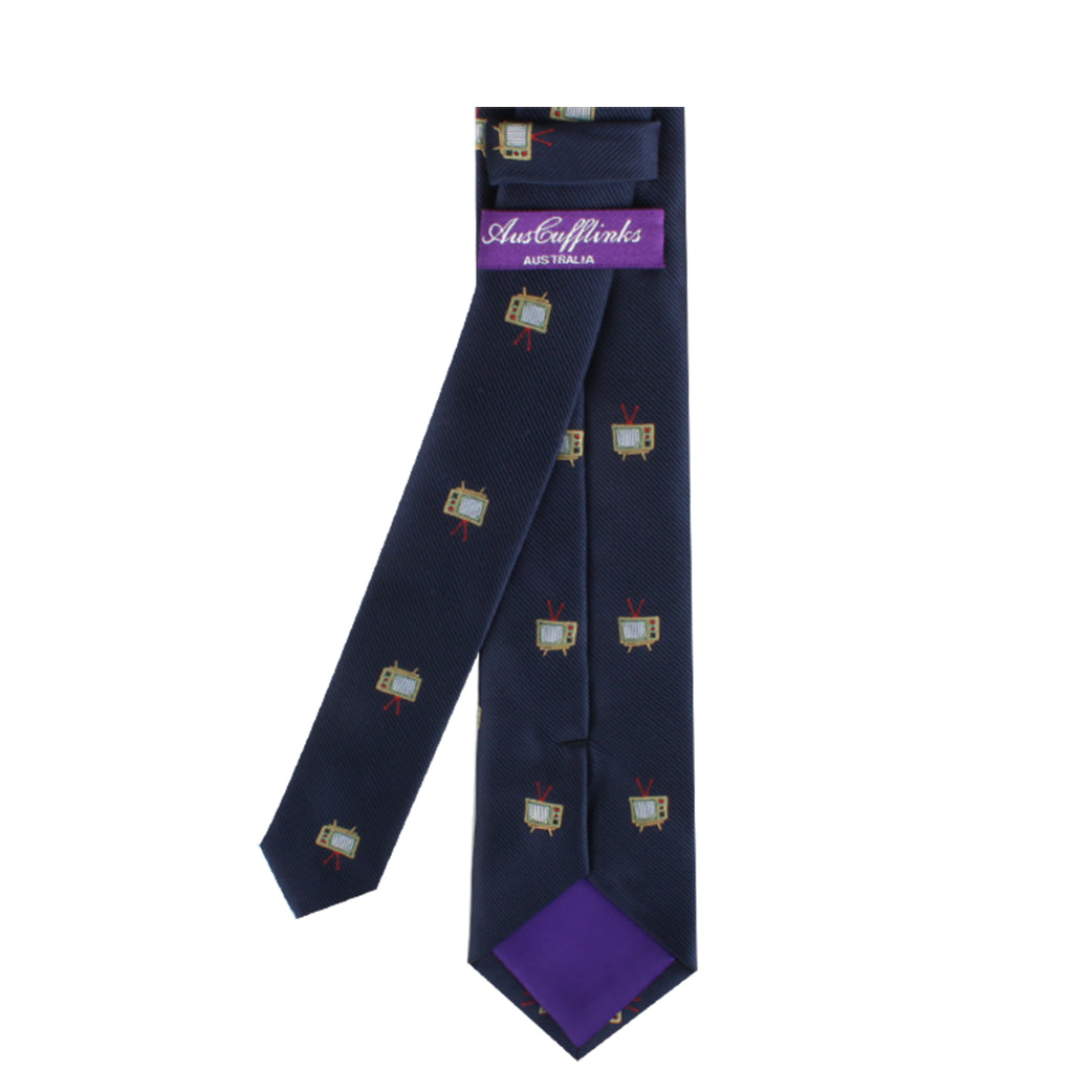 The TV Skinny Tie in navy blue, showcasing small vintage television designs, brings a playful touch to your outfit. Its purple inner lining adds an elegant element, and the brand label reads "AusterHinks Australia.