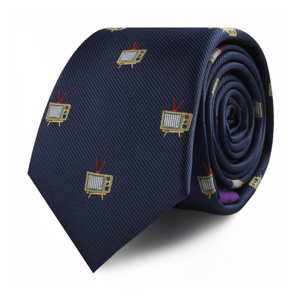 The TV Skinny Tie is a rolled navy blue necktie featuring a pattern of small, vintage television illustrations, adding an elegant touch to any entertainment enthusiast’s wardrobe.