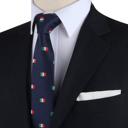 A man wears a dark suit with a white shirt and an Italian Mexican Flag Skinny Tie elegantly blending cultural elements, complemented by a visible white pocket square.