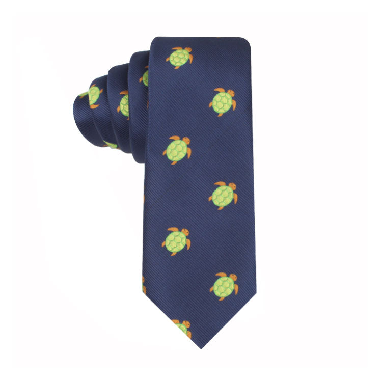 A navy blue Green Turtle Skinny Tie, exemplifying modern style, rolled up against a white background.