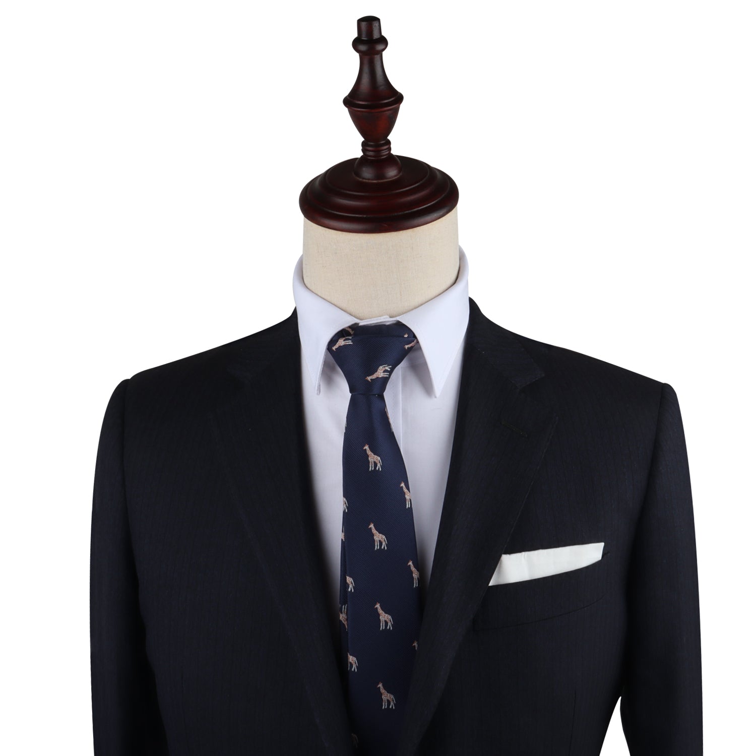 A suit on a mannequin stands tall, featuring a dark jacket, white dress shirt, and the Giraffe Skinny Tie with a subtle small animal print. Sophistication is elevated with the addition of a crisp white pocket square tucked into the breast pocket.