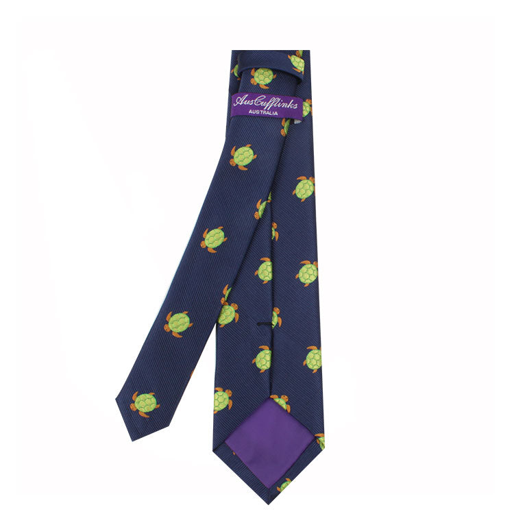 Green Turtle Skinny Tie with purple backing and a pattern of green turtles, exemplifying natural elegance, featuring the label "Robert Talbott Carmel.