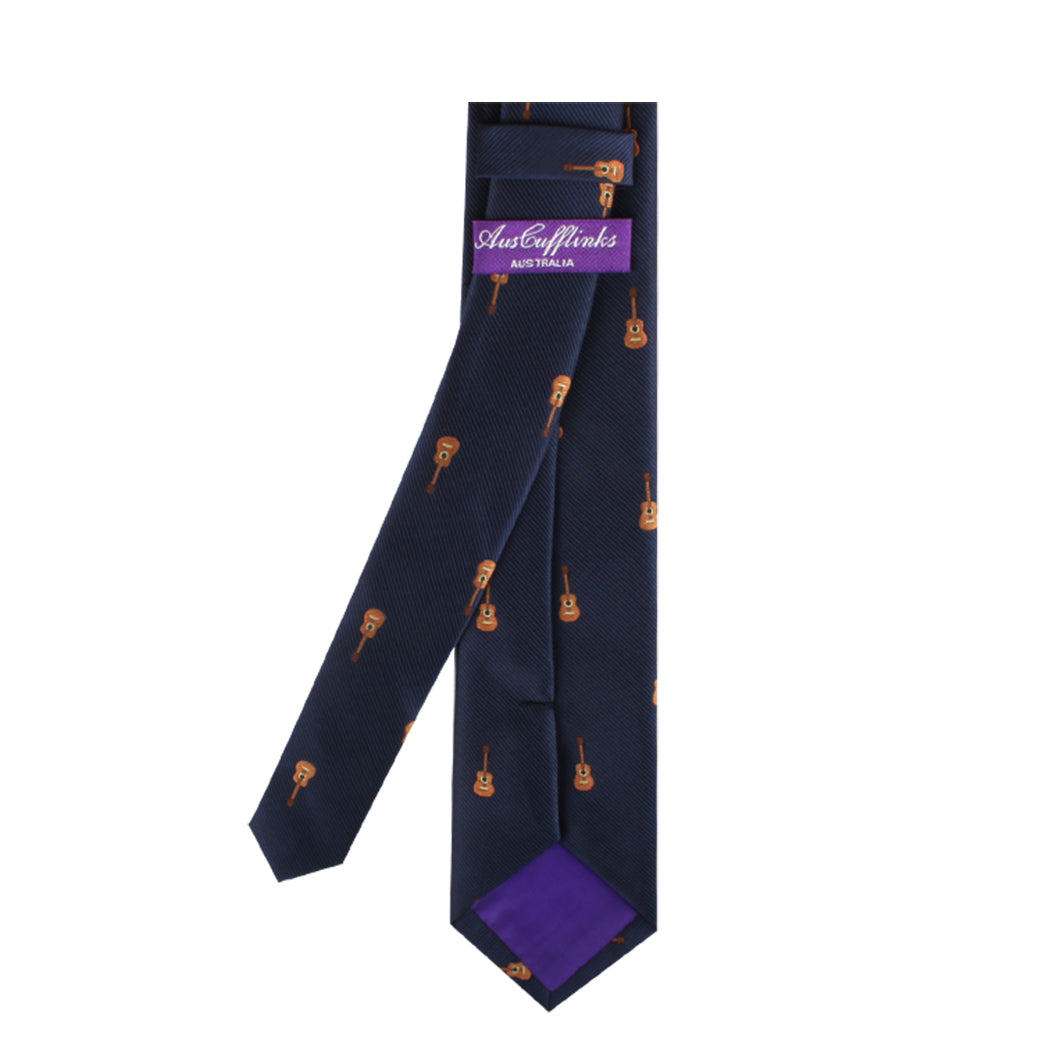 Guitar skinny tie with orange guitar patterns expressed in melodic passion and a purple tail, displayed against a white background.