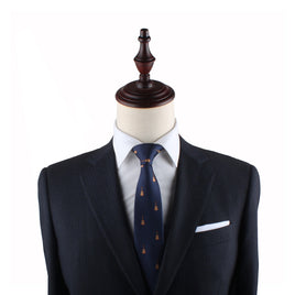 Mannequin torso dressed in a navy blue suit with a Guitar Skinny Tie and a white pocket square, set against a white background.