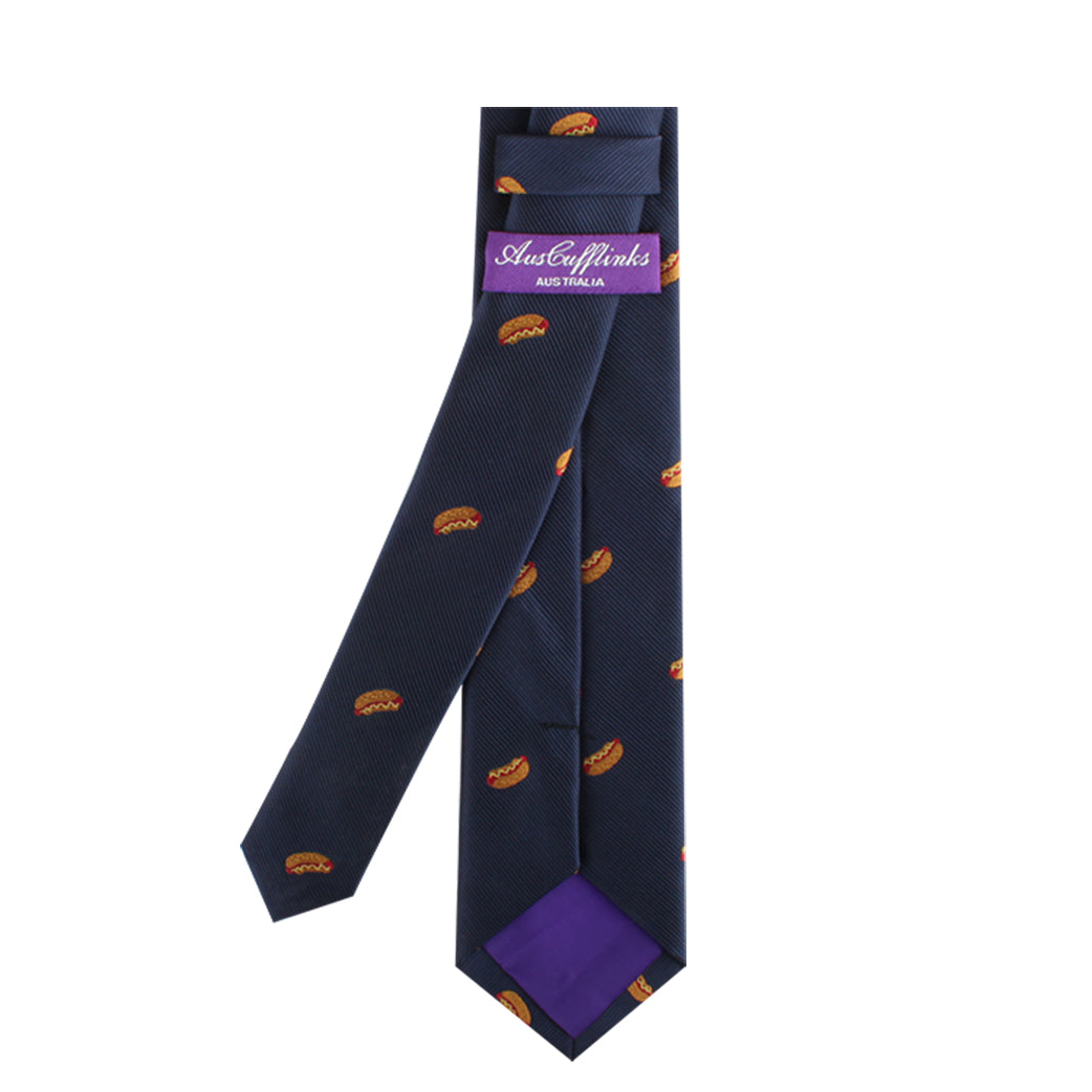 The navy blue Hotdog Skinny Tie, decorated with small orange burger patterns, exudes culinary charisma and features a purple label displaying the brand name "AustCufflinks Australia.