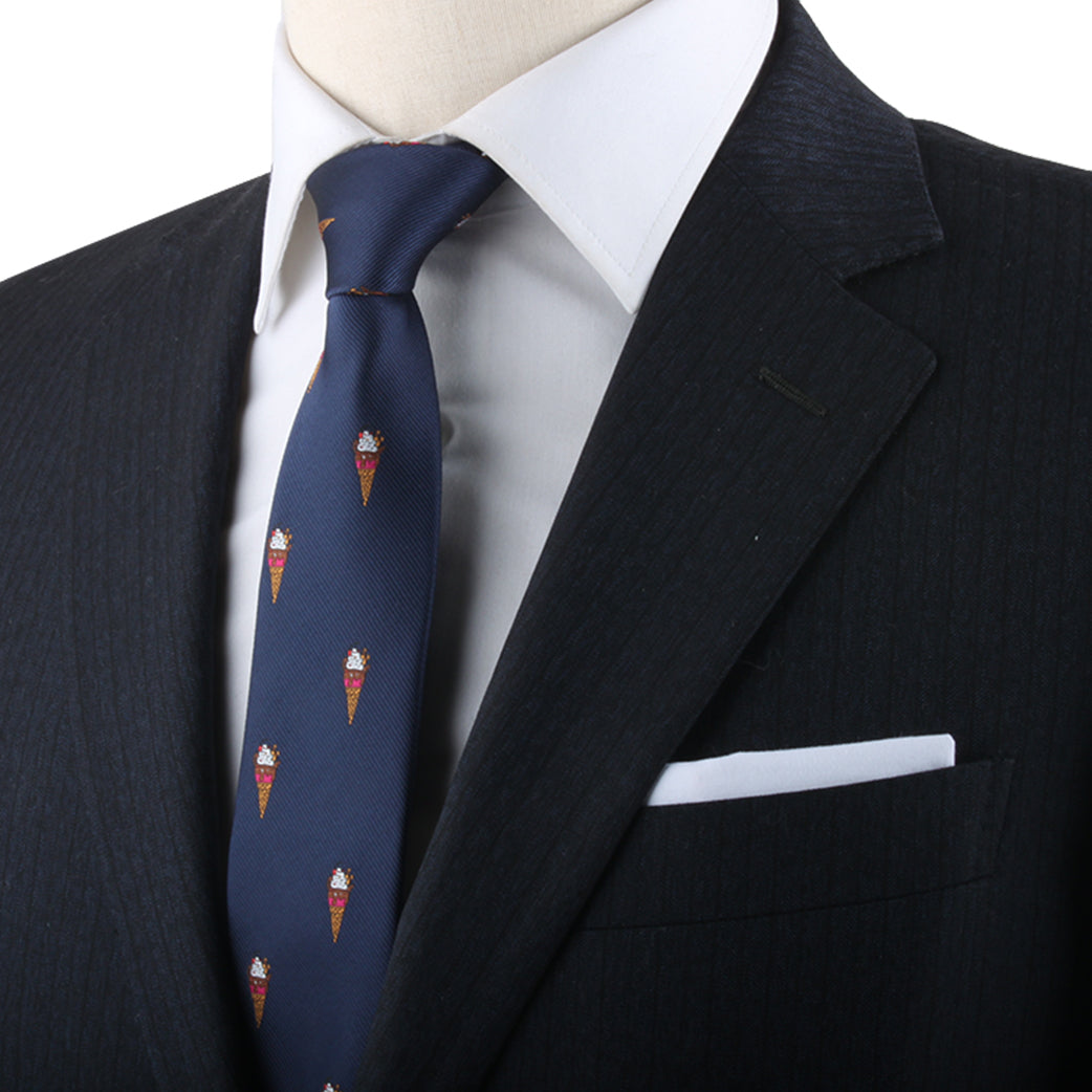 Close-up of a man's navy suit, white shirt, and Ice Cream Skinny Tie showcasing impeccable style.