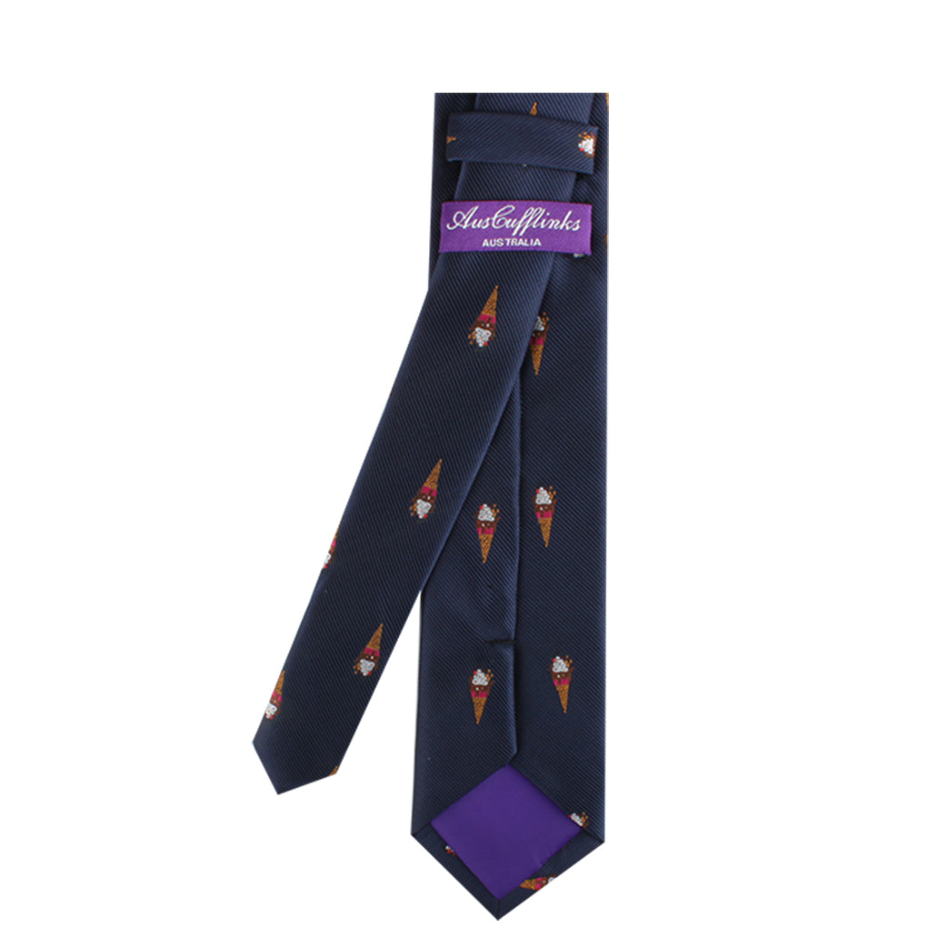 A Navy Blue Ice Cream Skinny Tie with a pattern of small, colorful ice cream cones, featuring a purple tail and a justcutpinks label, adds a touch of sweetness to your style.